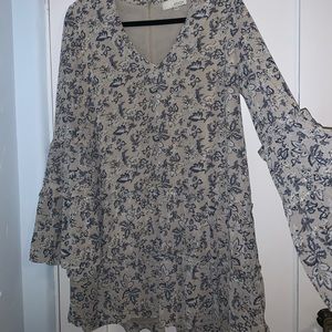 Greg and blue floral dress with plunging neckline